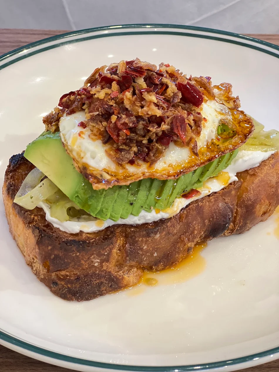 Focaccia toast topped with avocado, fried egg and crispy chilli at Ernest Deli